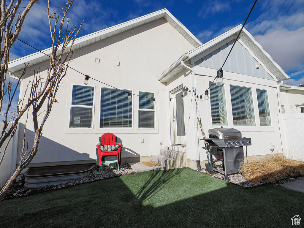 Rear view of house with a yard