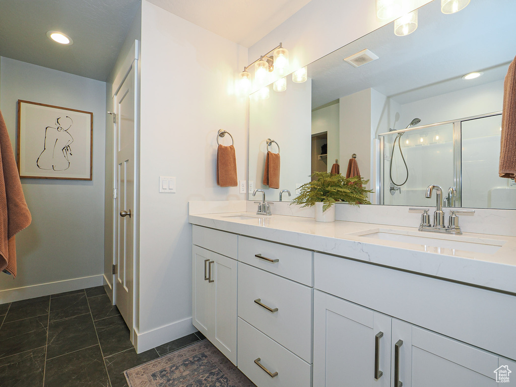 Bathroom featuring walk in shower and vanity