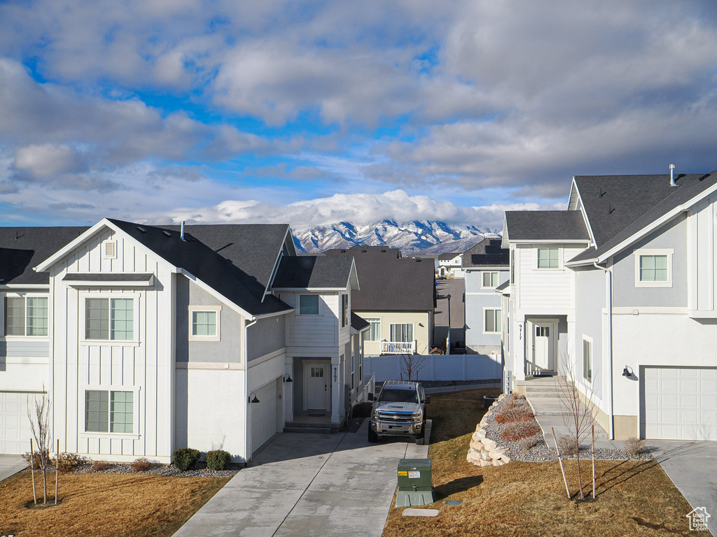 View of front of house featuring a mountain view and a garage