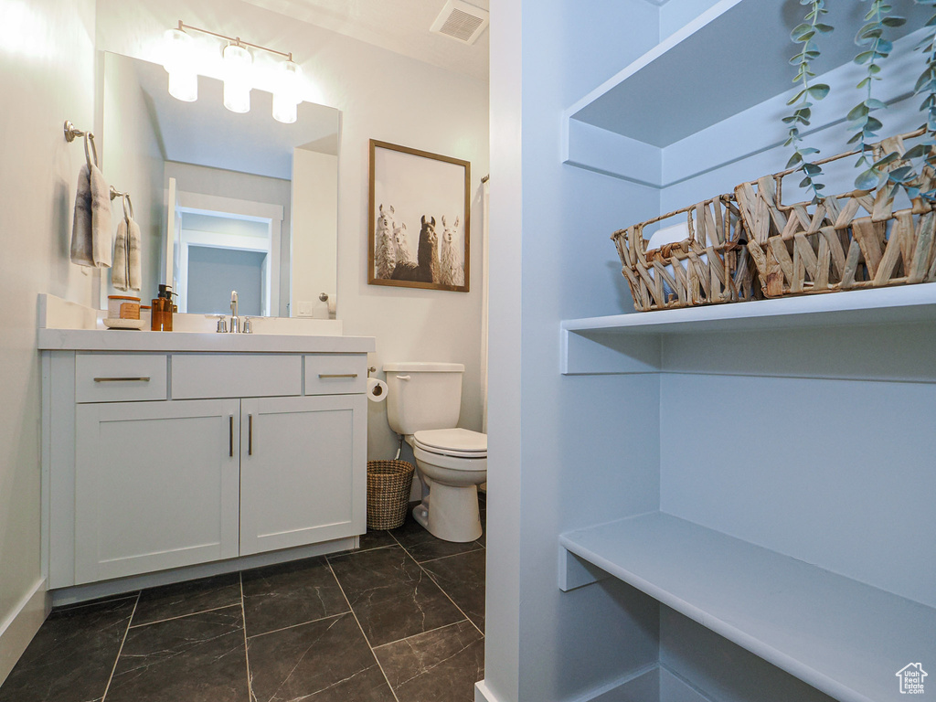 Bathroom featuring vanity and toilet