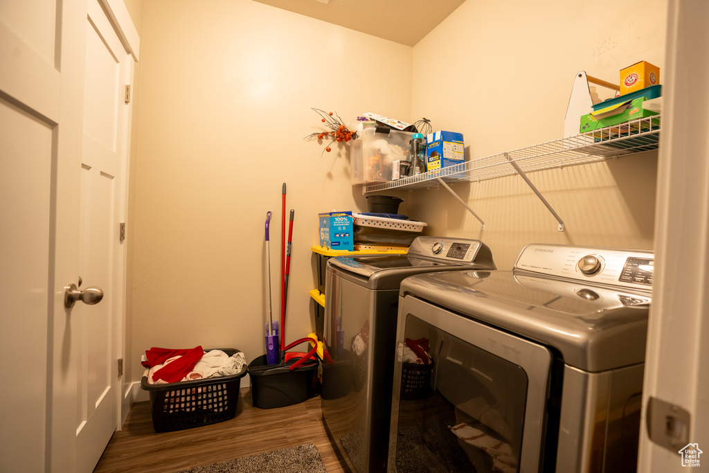 Washroom featuring washer and clothes dryer and wood-type flooring