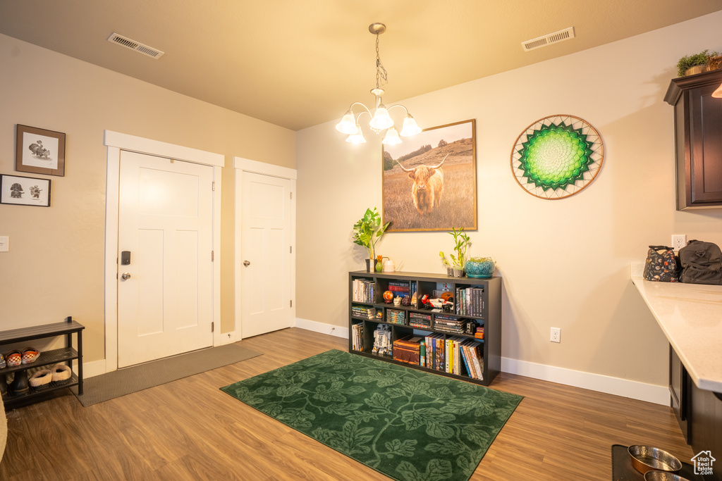 Entrance foyer featuring a chandelier and dark hardwood / wood-style flooring