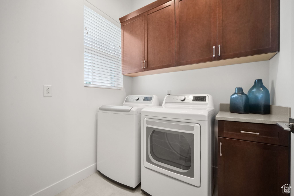 Washroom featuring cabinets and separate washer and dryer