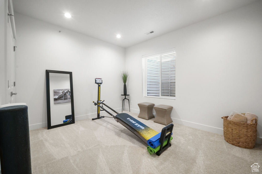 Exercise room with light colored carpet