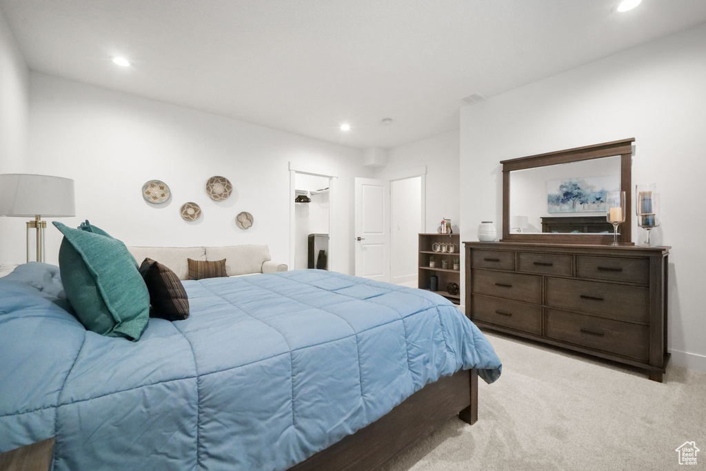 Bedroom featuring light carpet