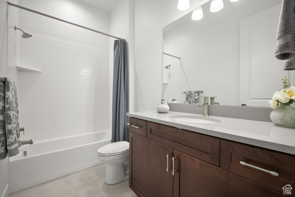 Full bathroom featuring tile patterned flooring, vanity, shower / bath combo, and toilet