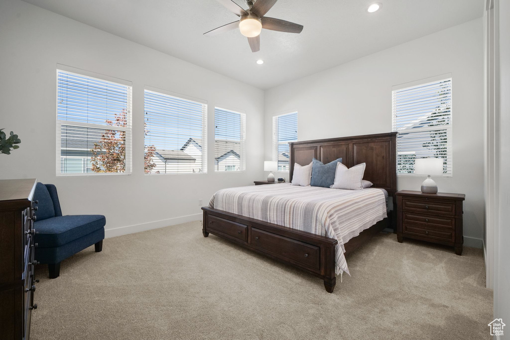 Carpeted bedroom featuring ceiling fan