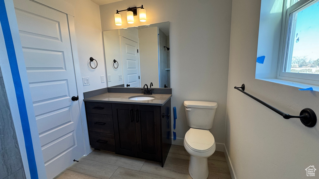 Bathroom featuring tile patterned flooring, vanity, and toilet