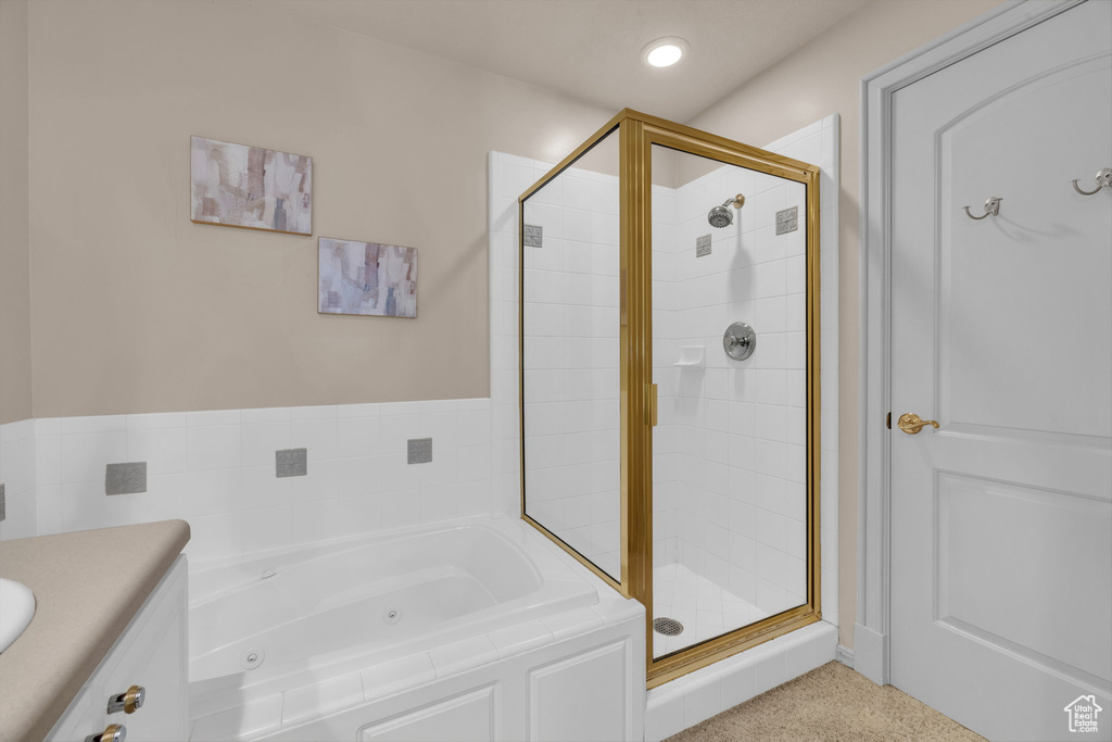 Bathroom featuring vanity and shower with separate bathtub