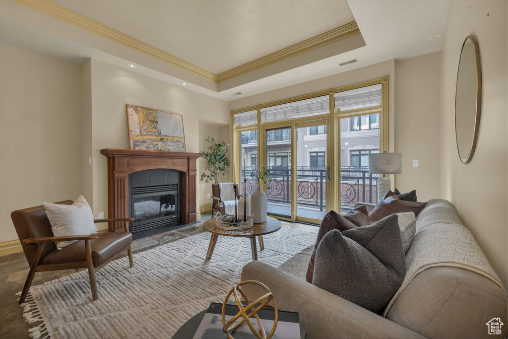 Living room featuring crown molding and a tray ceiling