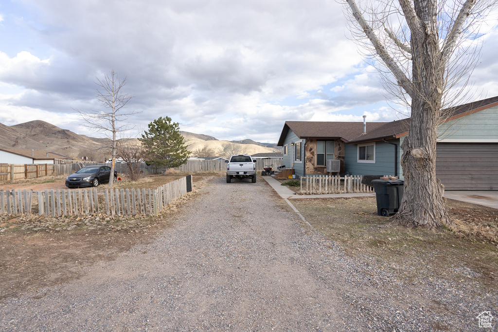 View of front of house with a garage and a mountain view