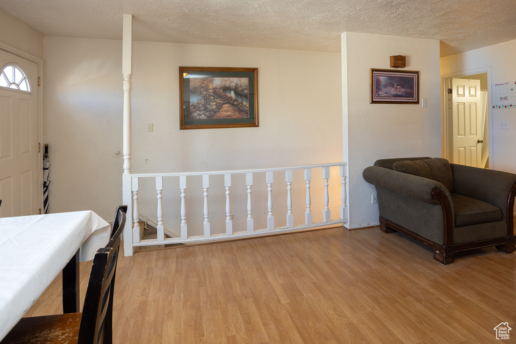 Entrance foyer featuring a textured ceiling and light hardwood / wood-style floors