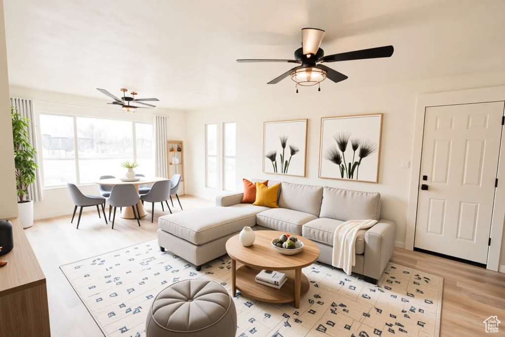 Living room featuring light wood-type flooring and a ceiling fan