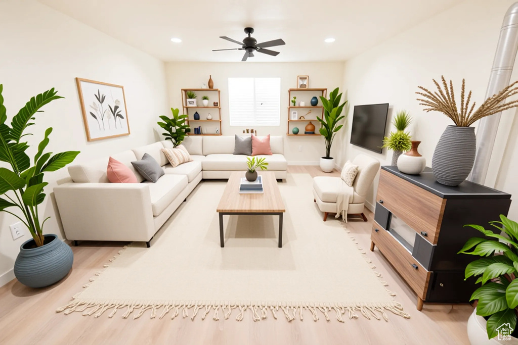 Living area featuring light wood-style floors, a ceiling fan, recessed lighting, and baseboards