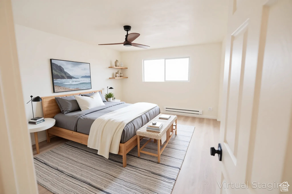 Bedroom with baseboard heating, wood finished floors, and ceiling fan