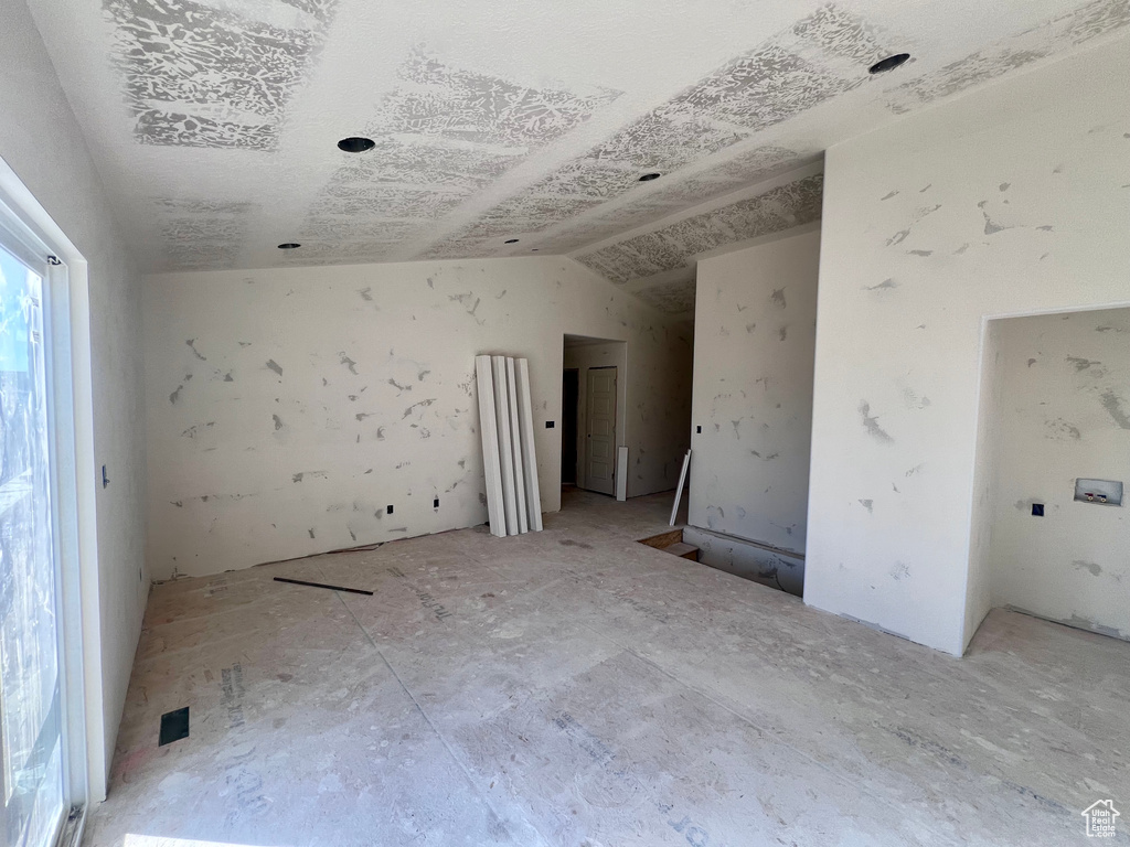 Spare room featuring vaulted ceiling