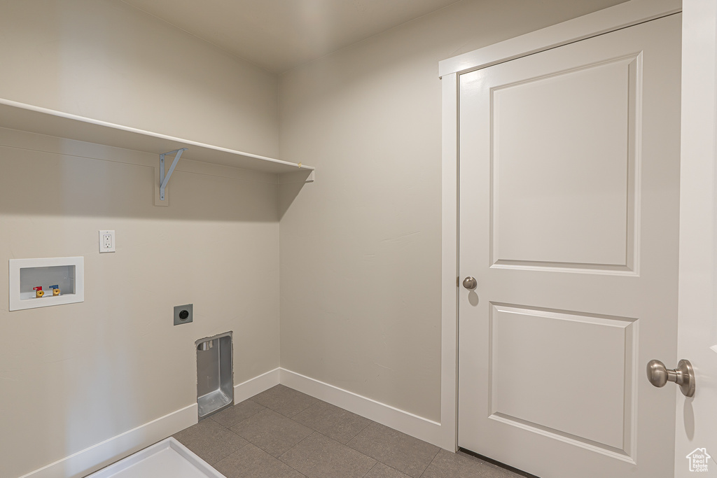 Clothes washing area featuring laundry area, hookup for a washing machine, baseboards, and hookup for an electric dryer