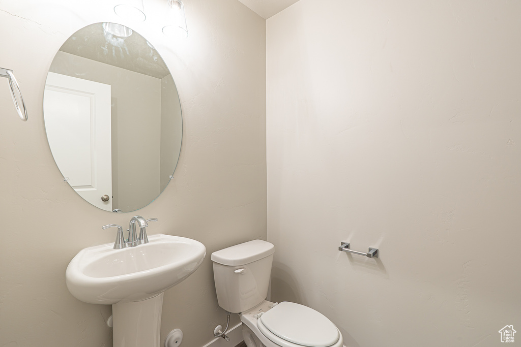 Bathroom featuring a sink and toilet