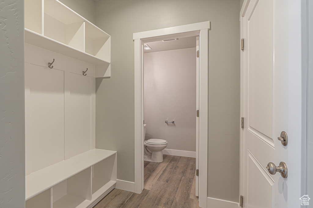 Mudroom featuring baseboards and light wood-type flooring