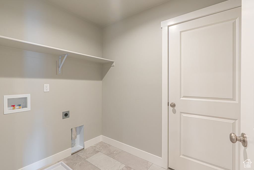 Laundry area featuring laundry area, marble finish floor, baseboards, hookup for a washing machine, and hookup for an electric dryer