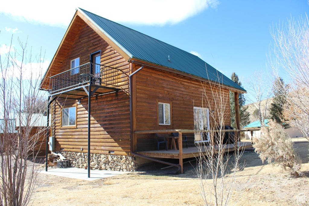 Rear view of property with a balcony