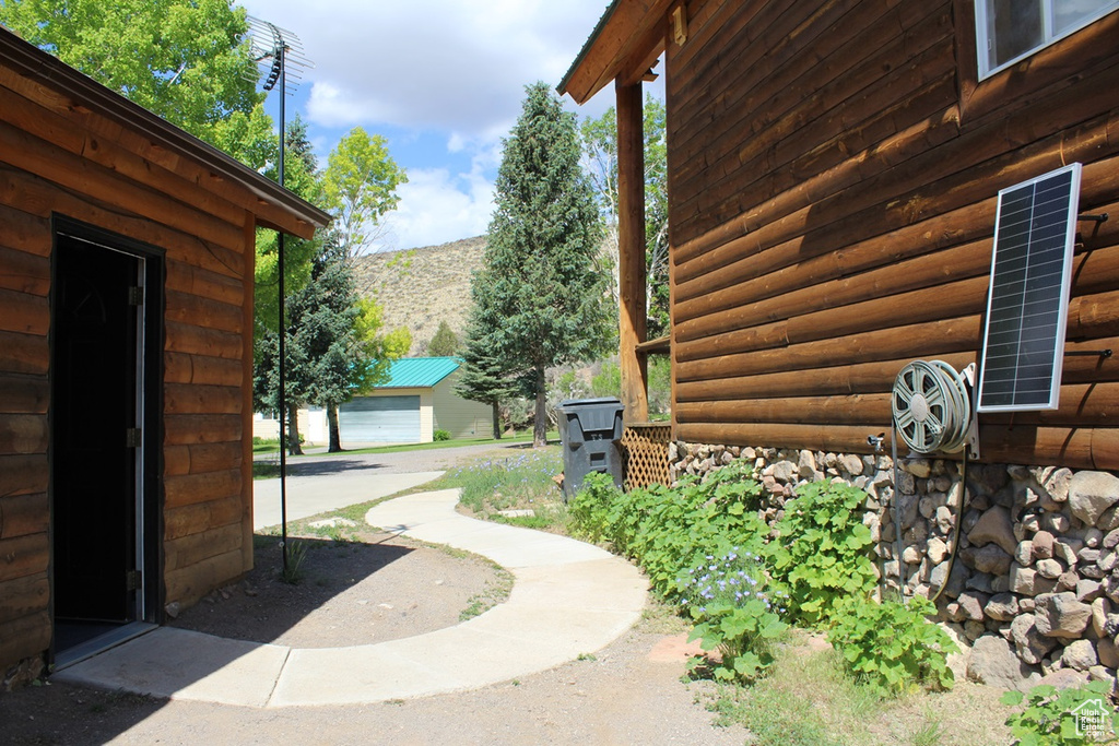 View of home\\\'s exterior featuring an outdoor structure and faux log siding