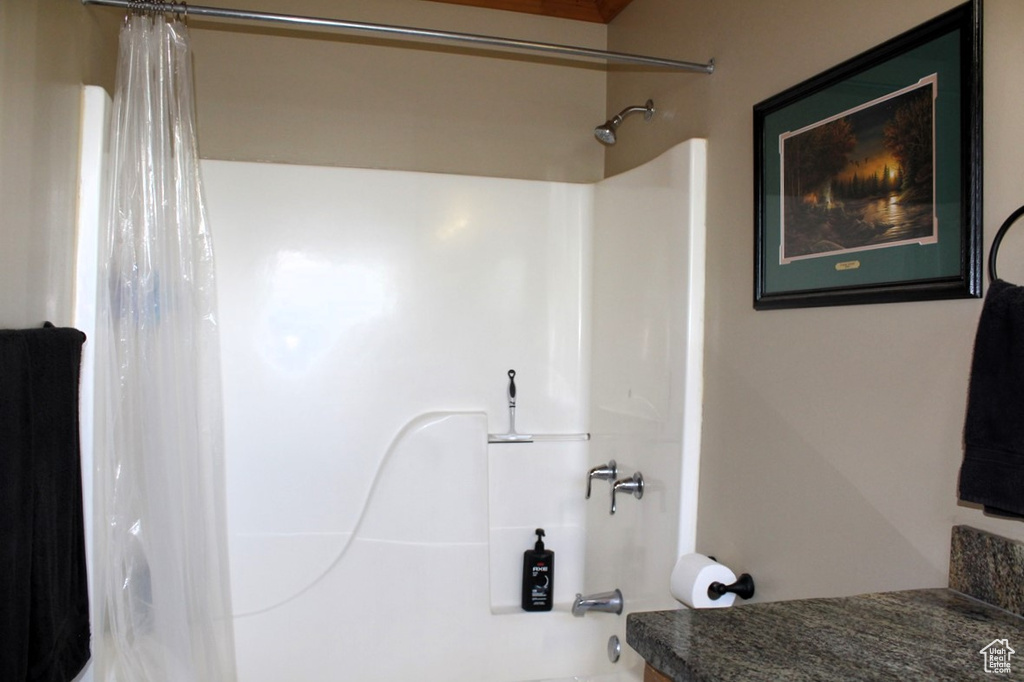 Bathroom with shower / bath combo and vanity