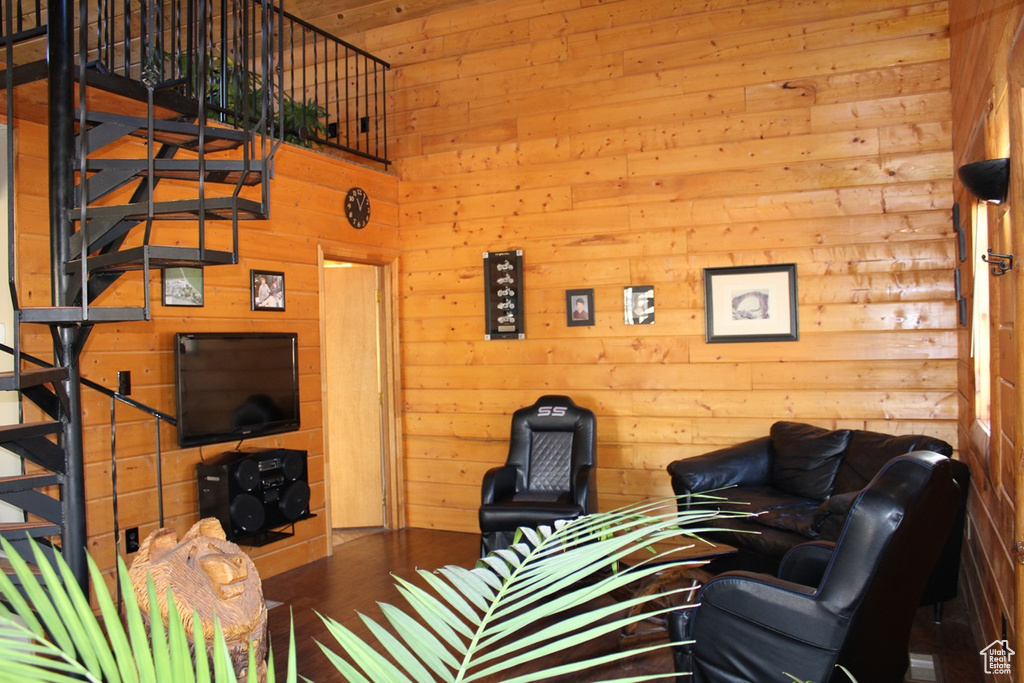 Living room featuring wooden walls and hardwood / wood-style floors