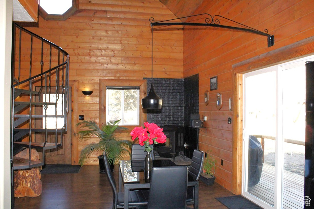 Dining room featuring dark wood-type flooring and wood walls