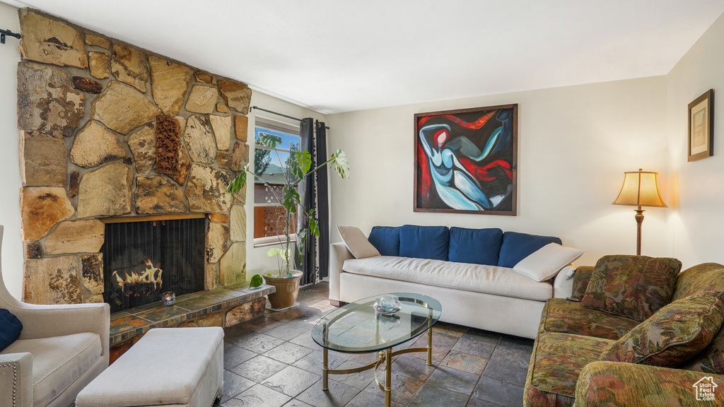 Living area with stone tile floors and a stone fireplace