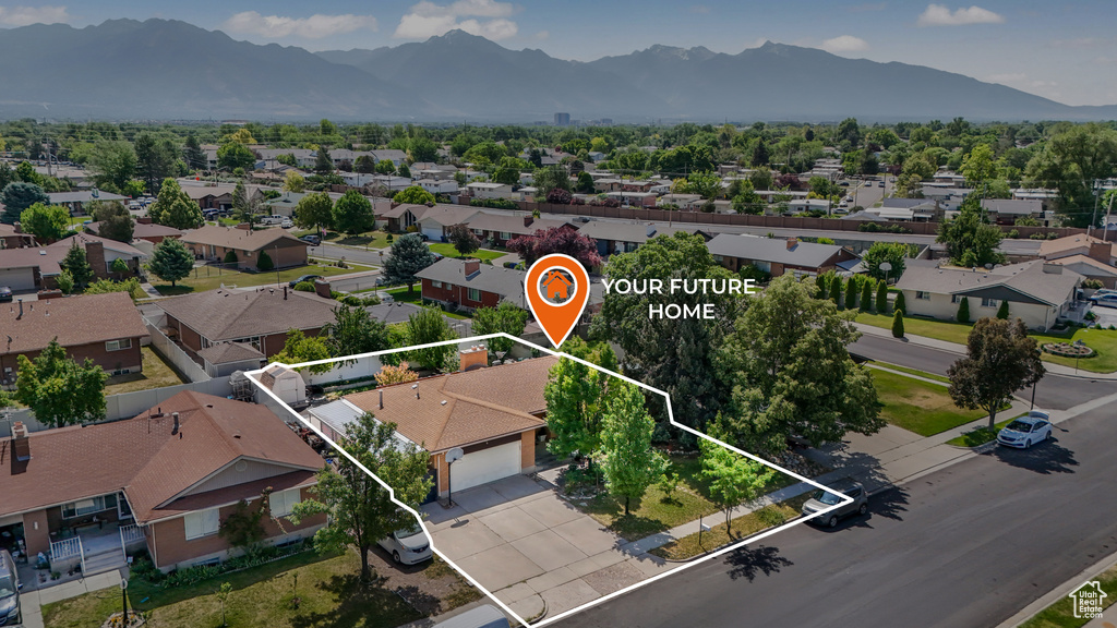 Aerial view of residential area with mountains and property boundaries highlighted