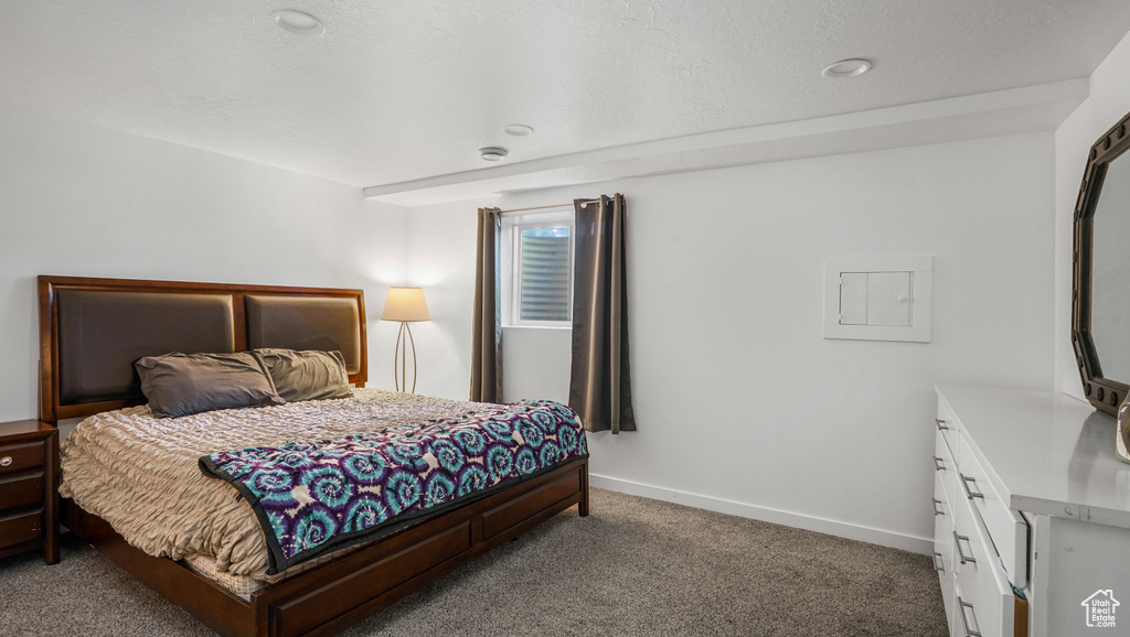 Bedroom featuring carpet flooring and baseboards
