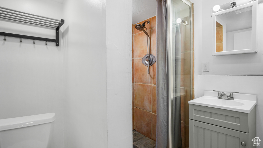 Full bath with a shower stall and vanity