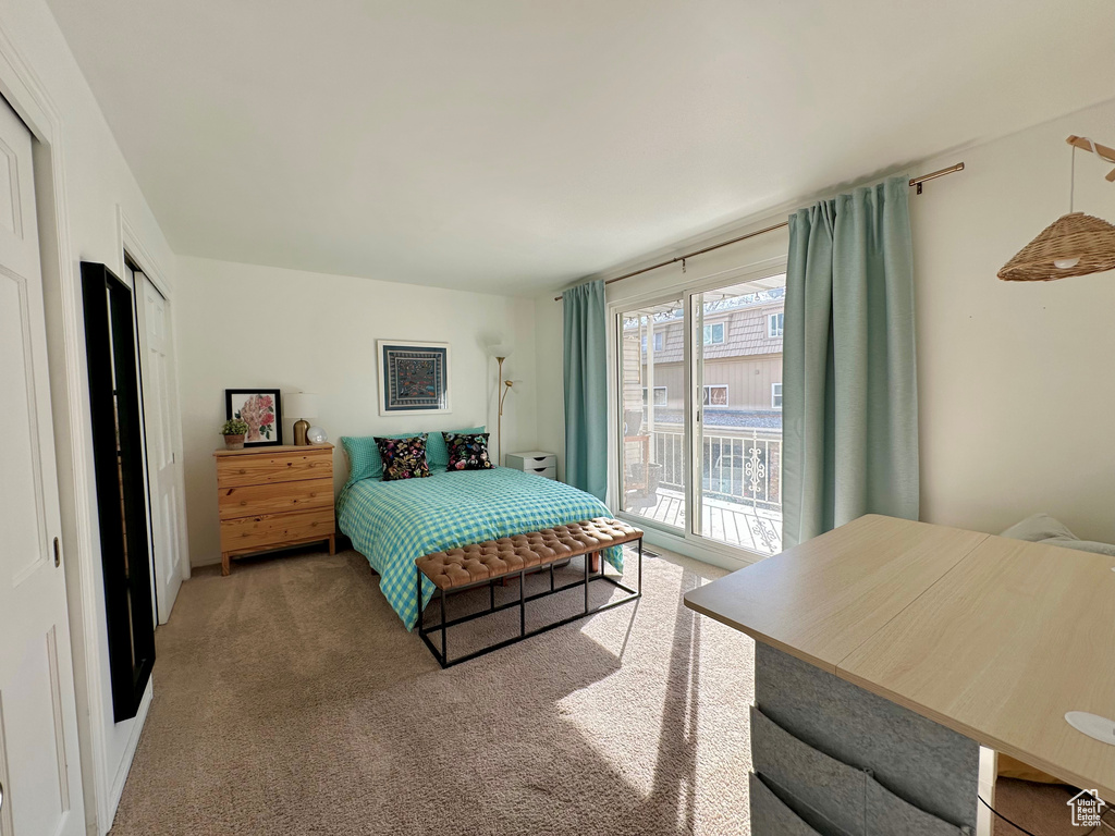 Carpeted bedroom featuring access to outside