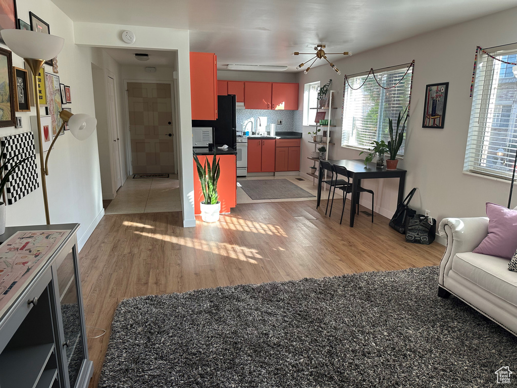 Interior space featuring light wood-style floors, baseboards, and ceiling fan