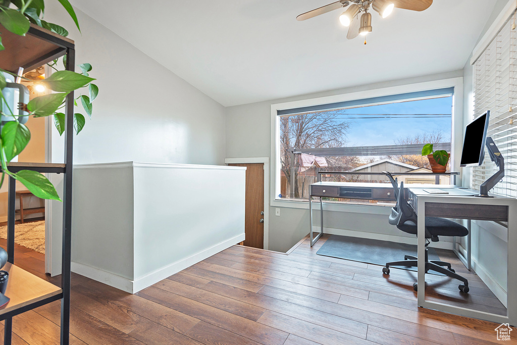 Office area featuring hardwood / wood-style flooring and vaulted ceiling