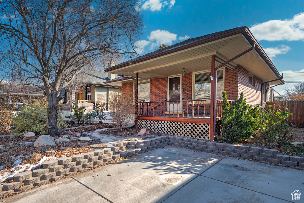 View of front facade featuring a porch and a patio area