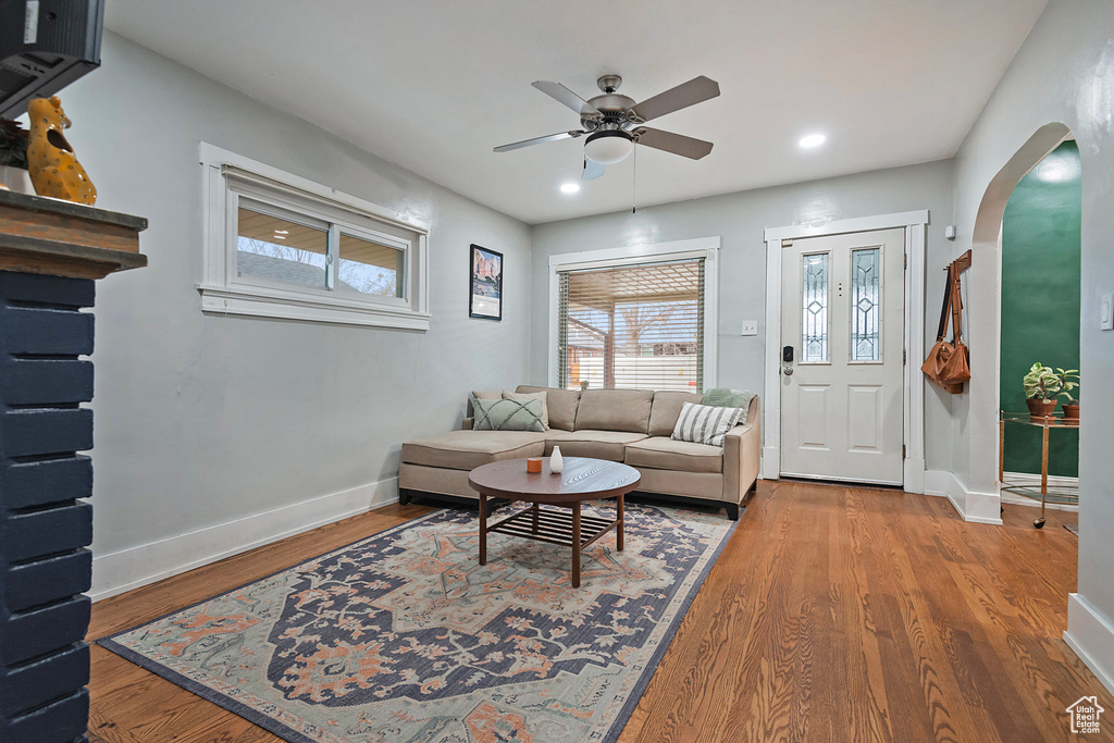 Living room featuring wood-type flooring and ceiling fan