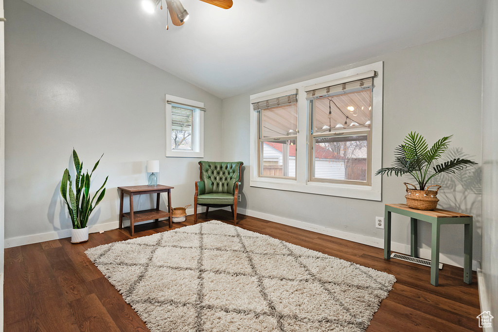 Sitting room with dark wood-type flooring, ceiling fan, and lofted ceiling