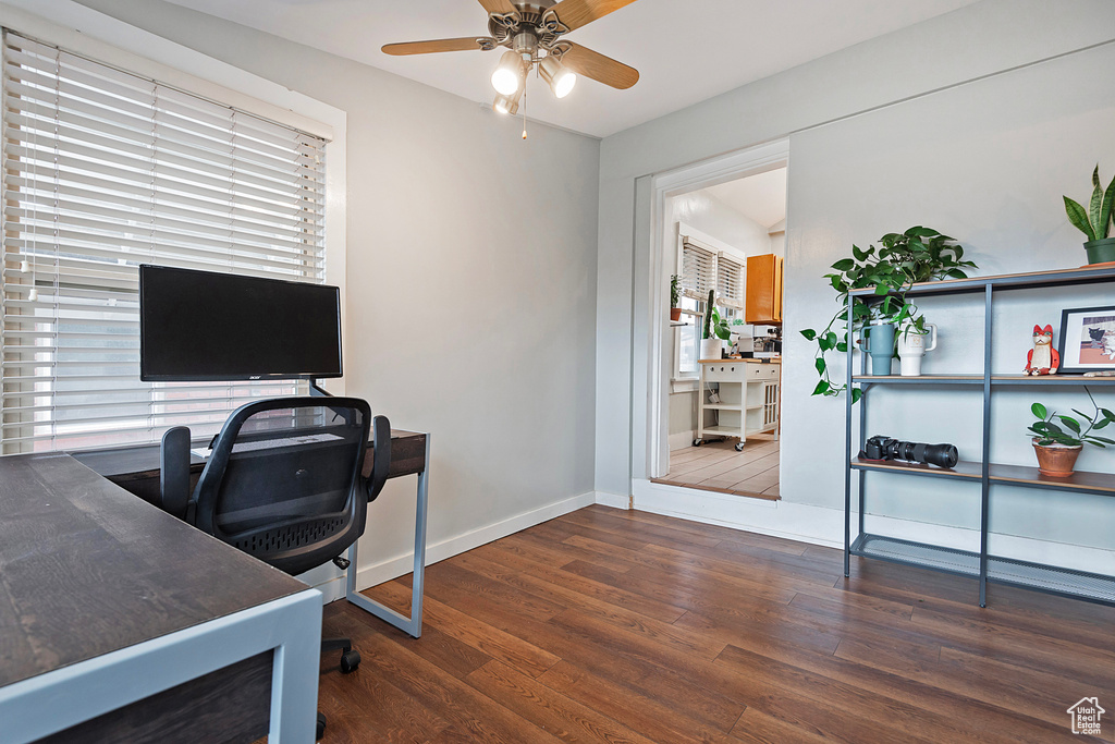 Office area featuring dark wood-type flooring and ceiling fan