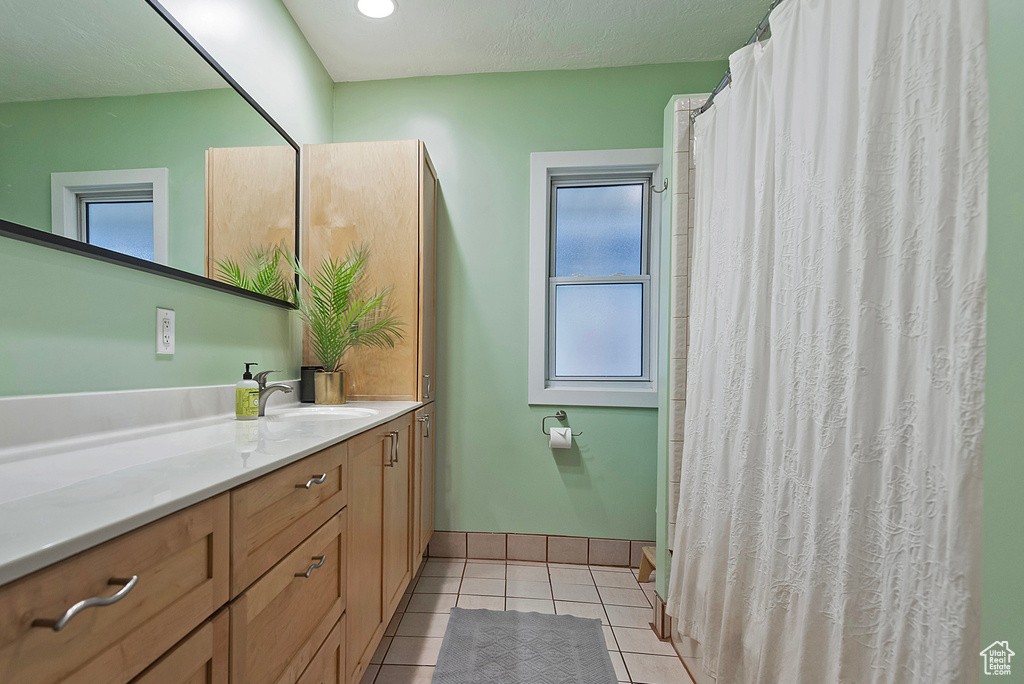 Bathroom featuring tile patterned floors and vanity