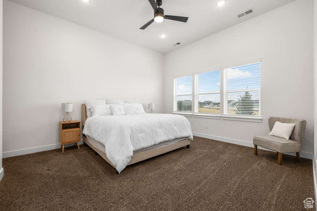 Carpeted bedroom featuring ceiling fan