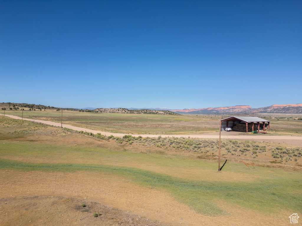 View of yard featuring a carport, a mountain view, and a rural view