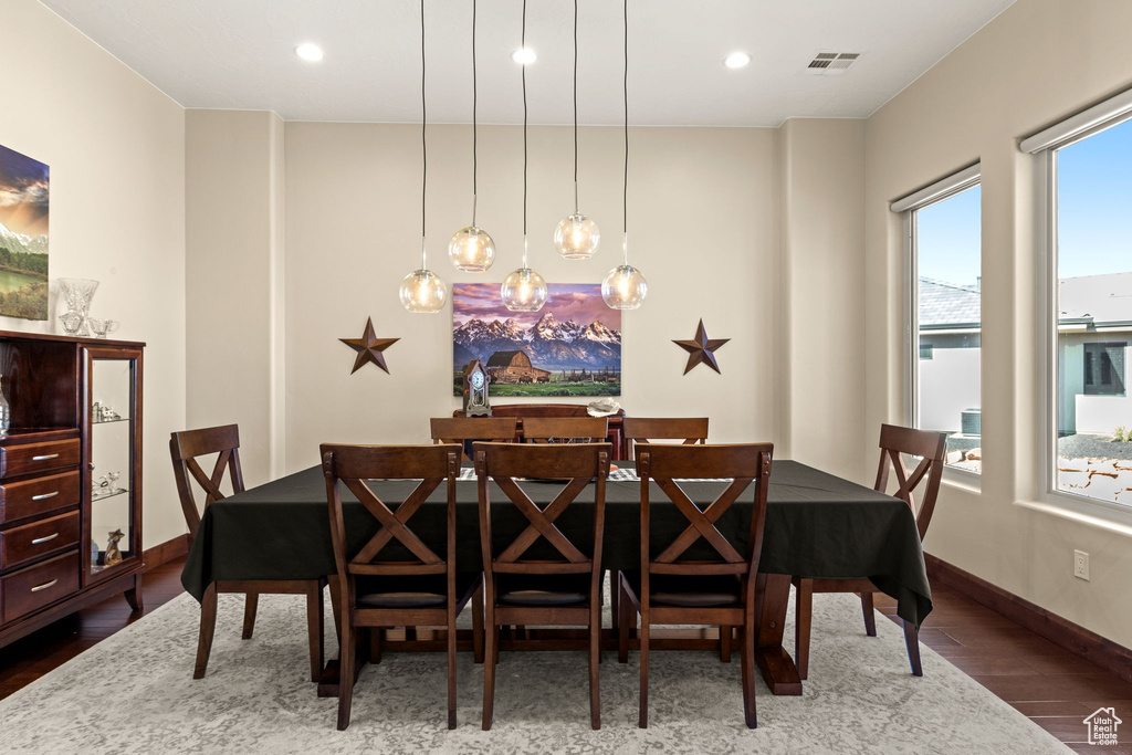 Dining area with wood-type flooring