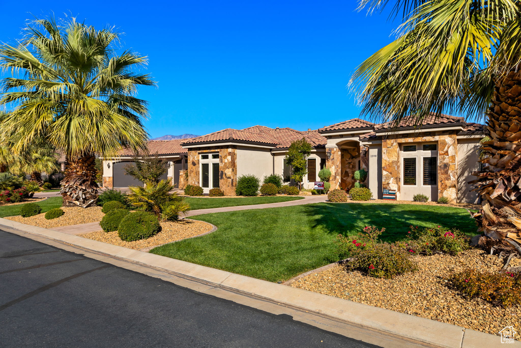 Mediterranean / spanish-style home featuring a front yard