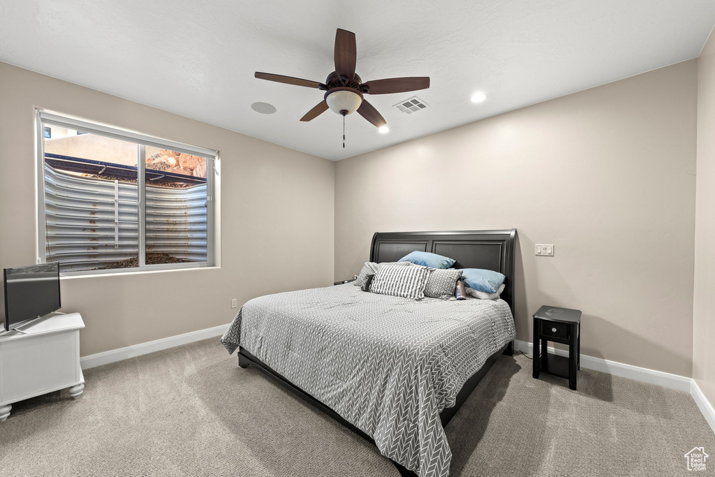 Carpeted bedroom with ceiling fan