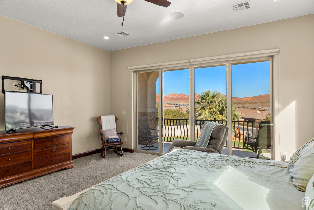 Carpeted bedroom with a mountain view, access to outside, and ceiling fan