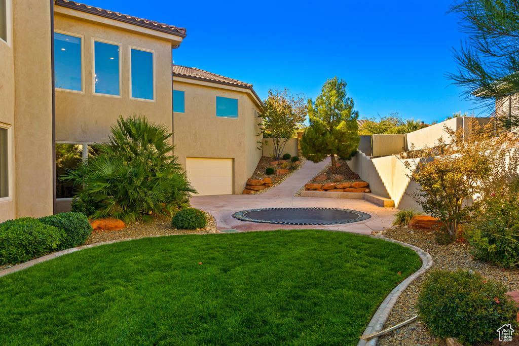 View of yard featuring a trampoline