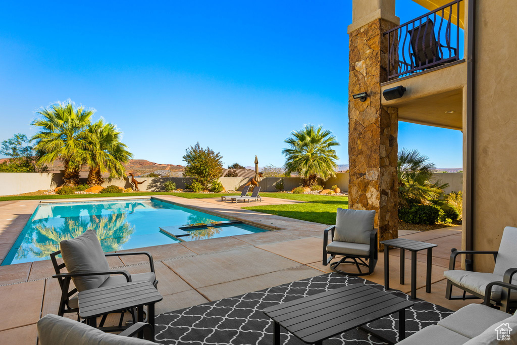 View of pool featuring a mountain view and a patio