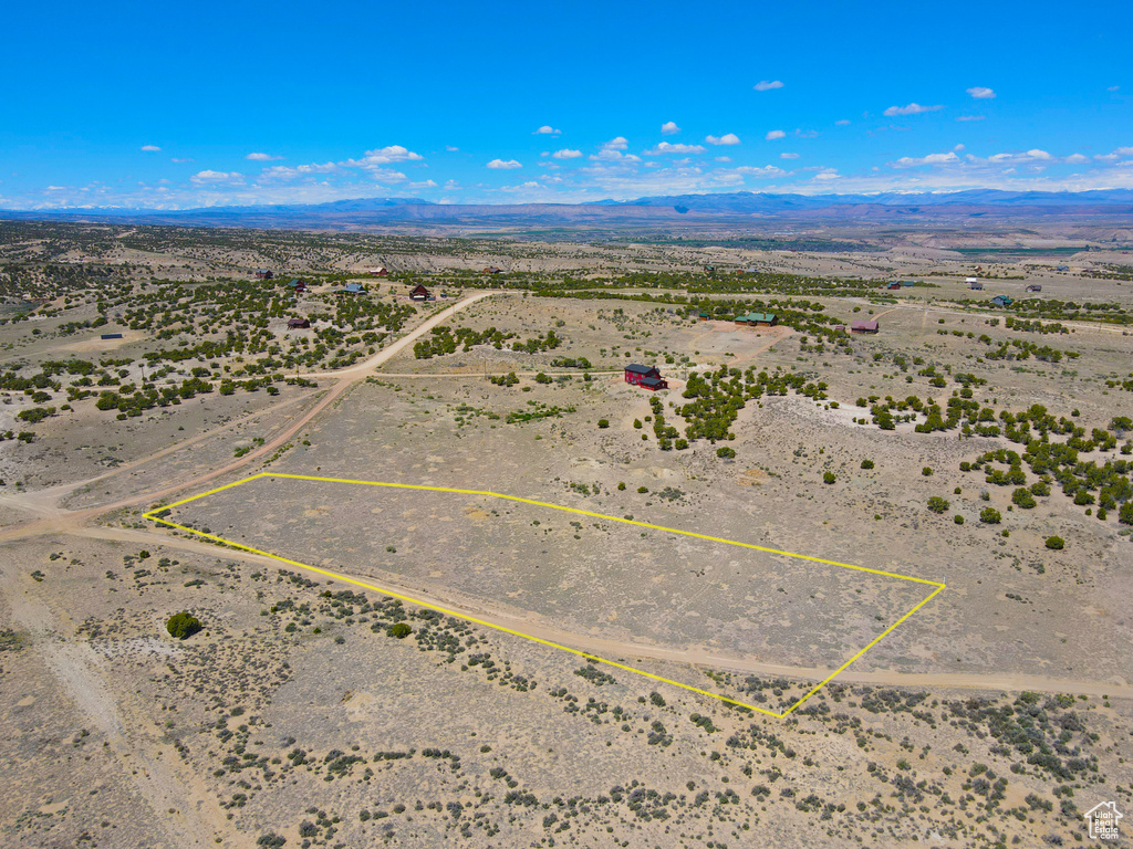 Overview of rural landscape featuring a desert landscape, a mountainous background, and property boundaries highlighted